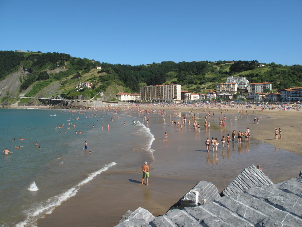 Deba beach on a summer day with the town behind