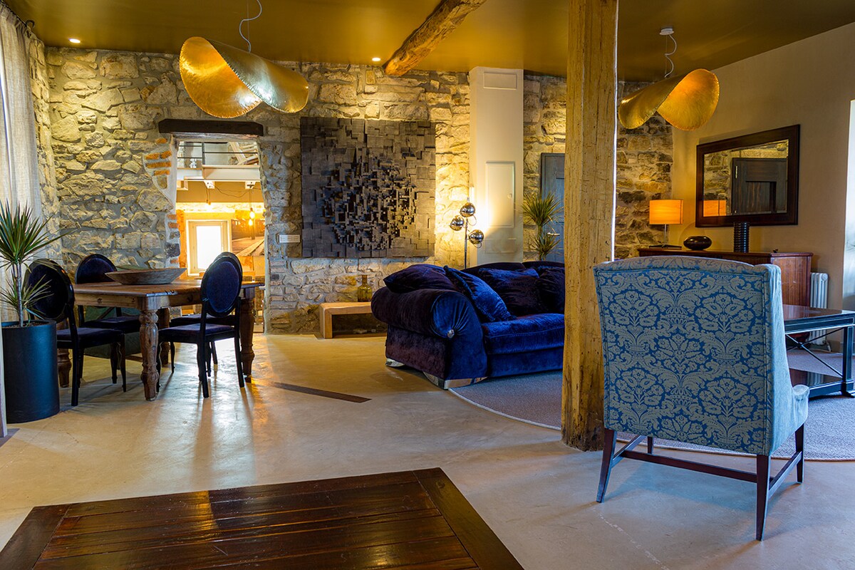 Living room with stone walls and ocean view